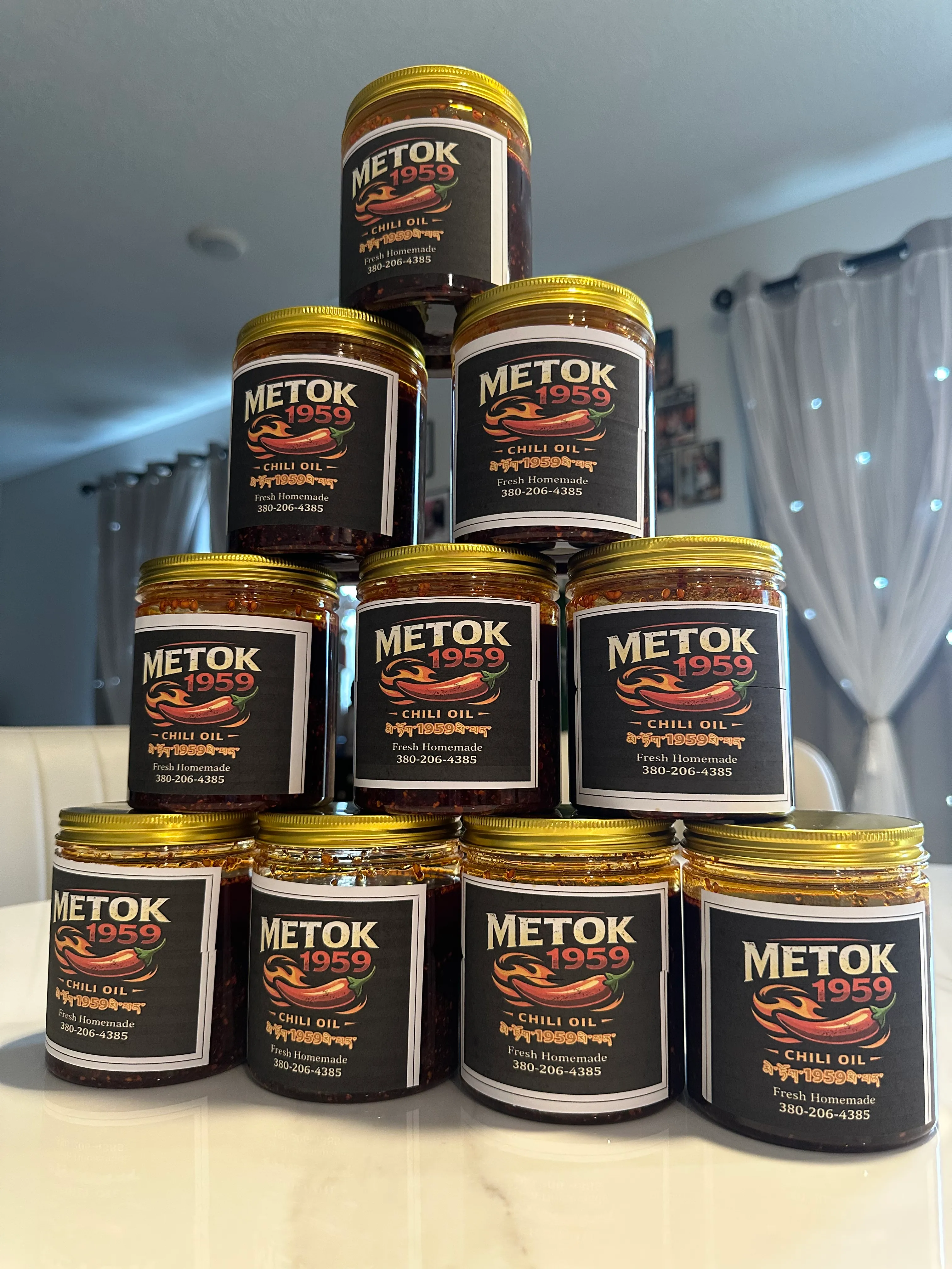 A pyramid of Metok 1959 chili oil jars with gold lids